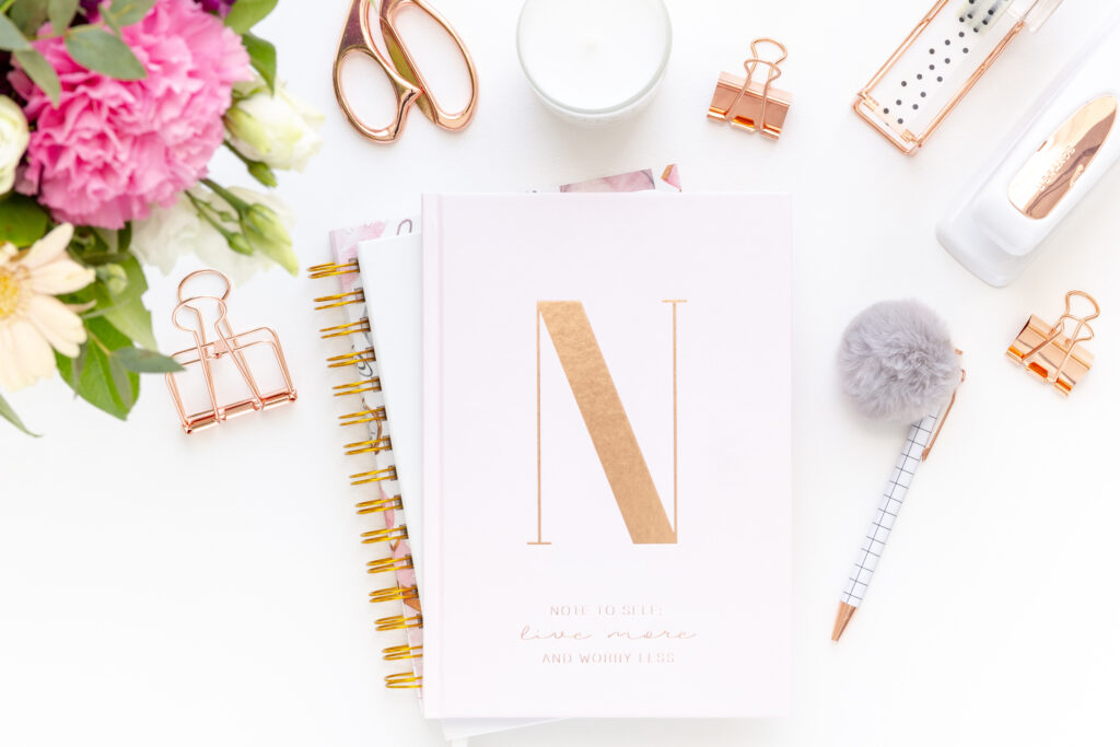 pink notebook on white desk